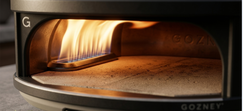 Close-up of the Gozney Arc's lateral gas burner and 20mm cordierite stone floor inside the oven