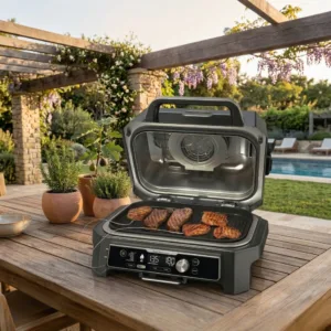 Ninja OG951 Woodfire Pro Connect XL outdoor grill and smoker on backyard patio.