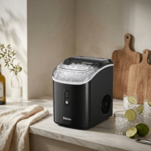 Silonn Nugget Ice Maker in black on a kitchen countertop next to a glass of iced drink
